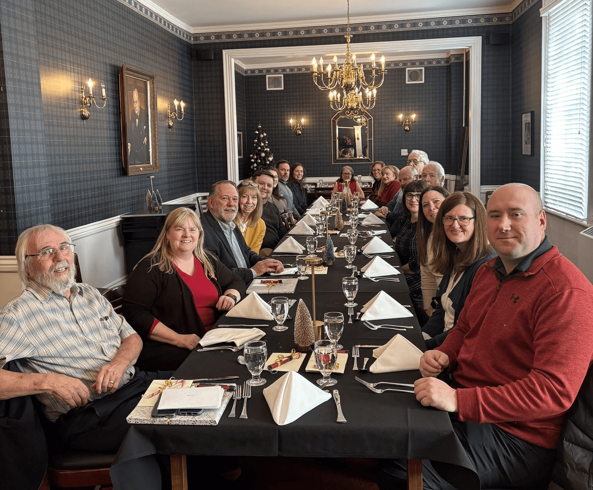Guests sharing a meal at a long dinner table